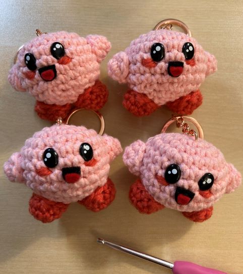 Four crocheted Kirby keychains